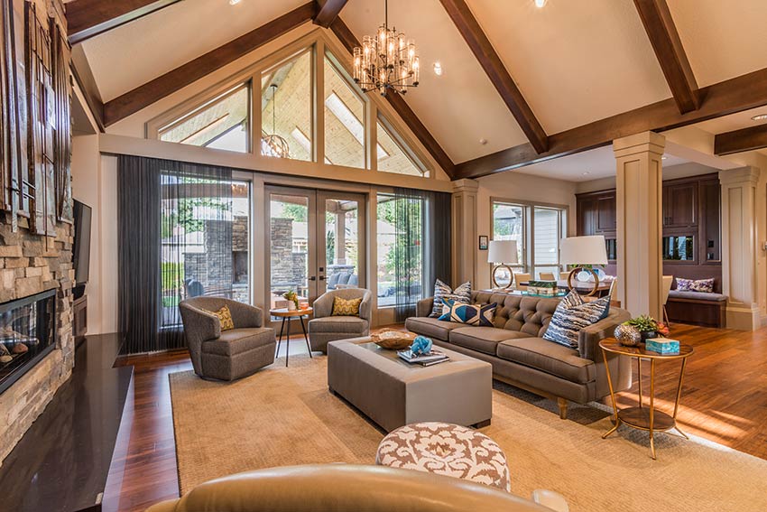 Living room with tall sloped ceilings and floor-to-ceiling windows