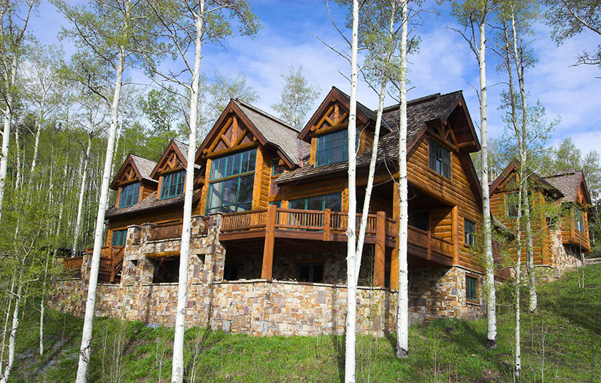 Luxury log cabin surrounded by birch trees